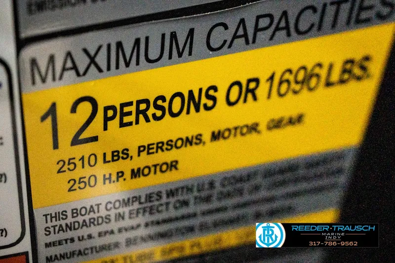Slide: The Image of 2026 Bennington 24 MFB boat capacity label: 12 persons, 1696 lbs, 250 HP motor. - 108