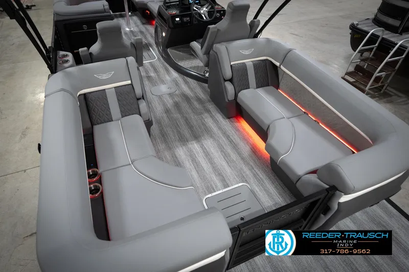 Slide: The Image of 2026 Bennington 24 MFB boat interior with gray seating and ambient lighting. - 14