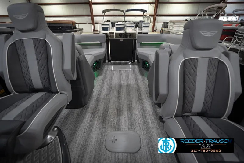 Slide: The Image of 2026 Bennington 24 MFB pontoon boat interior with gray seating and ambient lighting. - 16