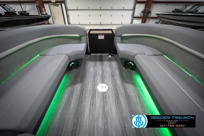 Slide: The Image of 2026 Bennington 24 MFB pontoon boat interior with gray seating and green LED lighting. - 21