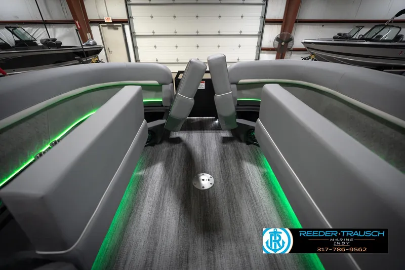 Slide: The Image of 2026 Bennington 24 MFB boat interior with gray seating and green accent lighting. - 22