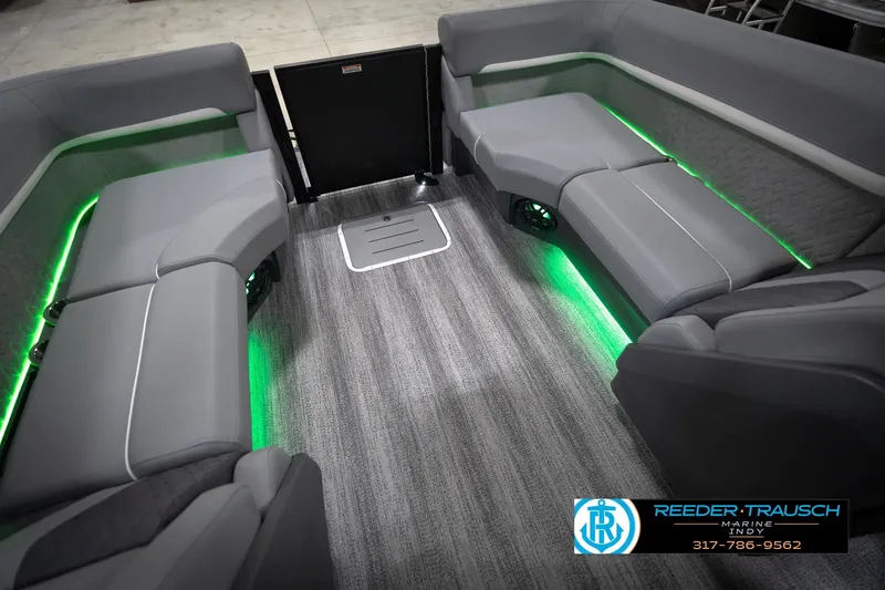 Slide: The Image of 2026 Bennington 24 MFB boat interior with gray seating and green LED lighting. - 25