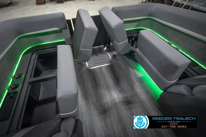 Slide: The Image of 2026 Bennington 24 MFB boat interior with gray seating and green LED lighting. - 26