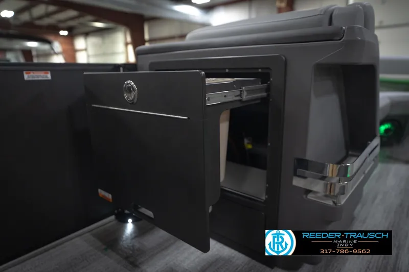 Slide: The Image of 2026 Bennington 24 MFB boat interior with gray seating and green LED lighting. - 28