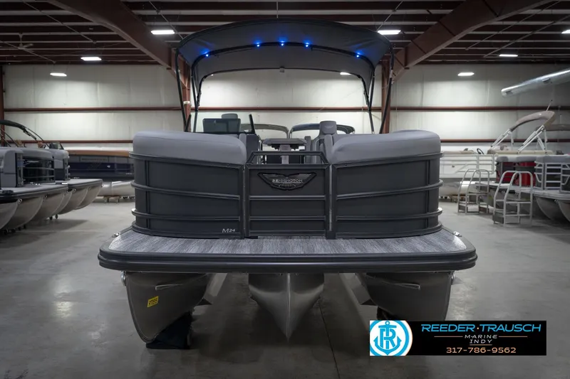 Slide: The Image of 2026 Bennington 24 MFB pontoon boat in showroom, featuring sleek design and modern amenities. - 4