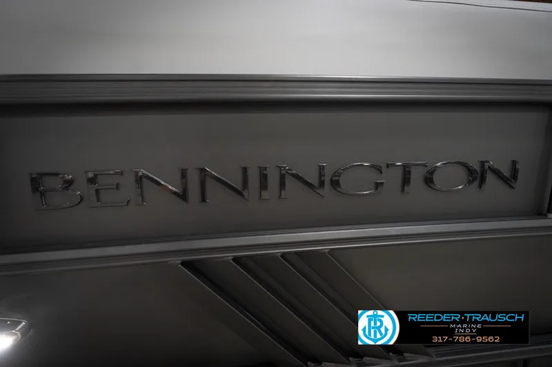 Slide: The Image of 2026 Bennington 24 MFB boat interior with gray seating and green LED lighting. - 49