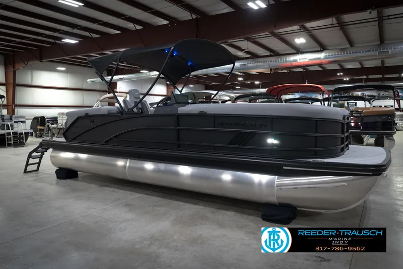 Slide: The Image of 2026 Bennington 24 MFB pontoon boat displayed indoors at Reeder-Trausch Marine showroom. - 5