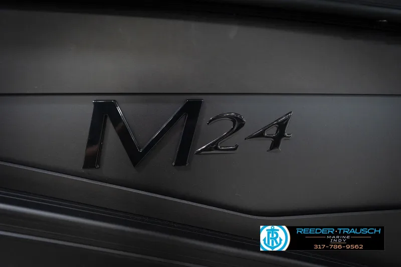 Slide: The Image of Luxurious seating in 2026 Bennington 24 MFB boat with ambient green lighting. - 50