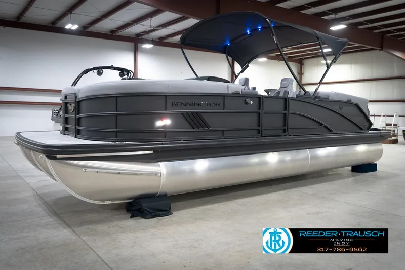 Slide: The Image of 2026 Bennington 24 MFB pontoon boat in a showroom with canopy and seating. - 57