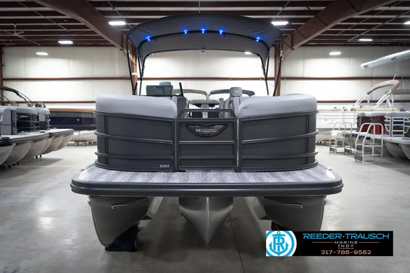 Slide: The Image of 2026 Bennington 24 MFB pontoon boat in showroom, featuring sleek design and modern amenities. - 58