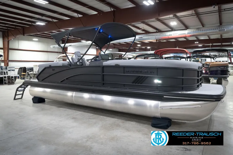 Slide: The Image of 2026 Bennington 24 MFB pontoon boat displayed indoors at Reeder-Trausch Marine showroom. - 59