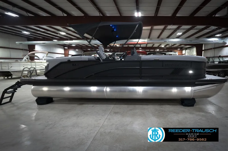 Slide: The Image of 2026 Bennington 24 MFB pontoon boat in showroom with sleek design and modern features. - 6