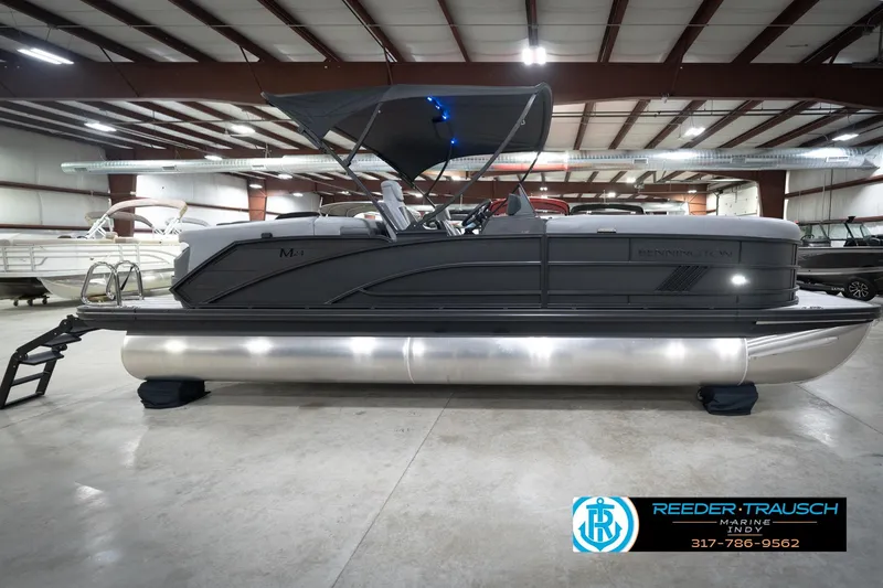 Slide: The Image of 2026 Bennington 24 MFB pontoon boat in showroom with sleek design and modern features. - 60