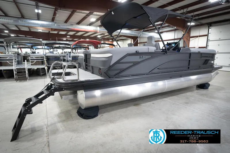 Slide: The Image of 2026 Bennington 24 MFB pontoon boat in showroom with canopy and ladder. - 61