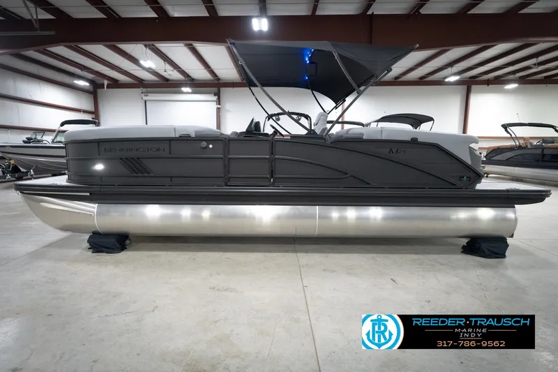 Slide: The Image of 2026 Bennington 24 MFB pontoon boat in showroom, side view with canopy. - 64