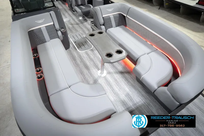 Slide: The Image of 2026 Bennington 24 MFB boat interior with gray seating and ambient lighting. - 66