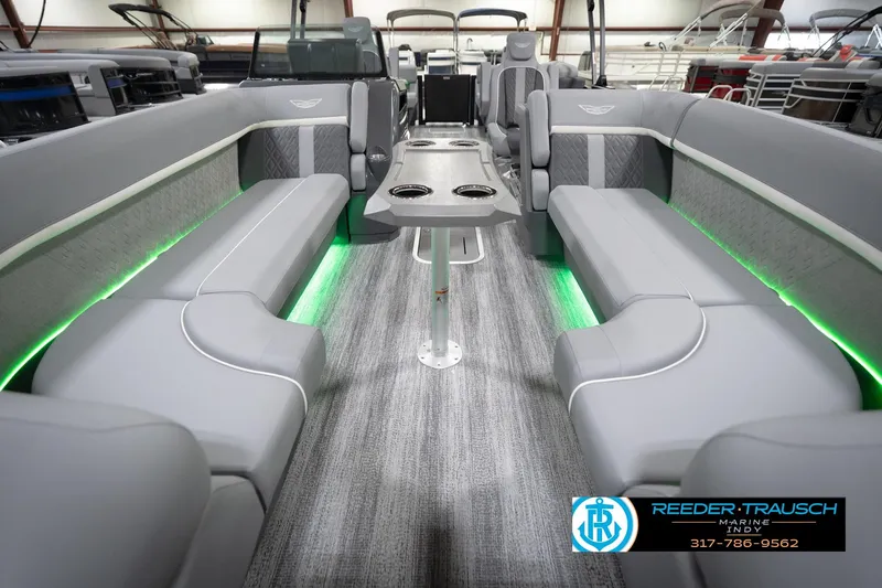 Slide: The Image of 2026 Bennington 24 MFB pontoon boat interior with gray seating and green LED lighting. - 69