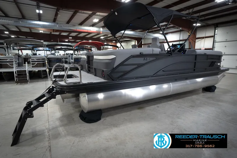 Slide: The Image of ```json { "alt_text": "2026 Bennington 24 MFB boat on water, promoting trade-in program." } ``` - 7