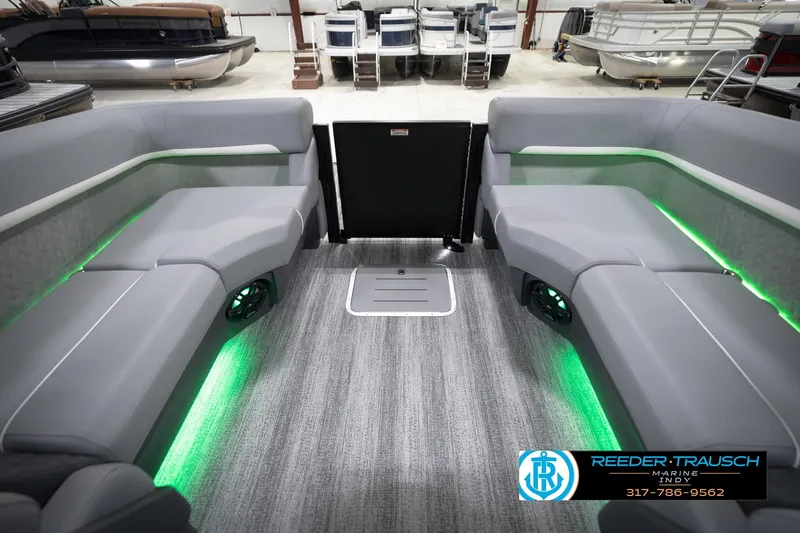 Slide: The Image of 2026 Bennington 24 MFB pontoon boat interior with gray seating and green LED lighting. - 71