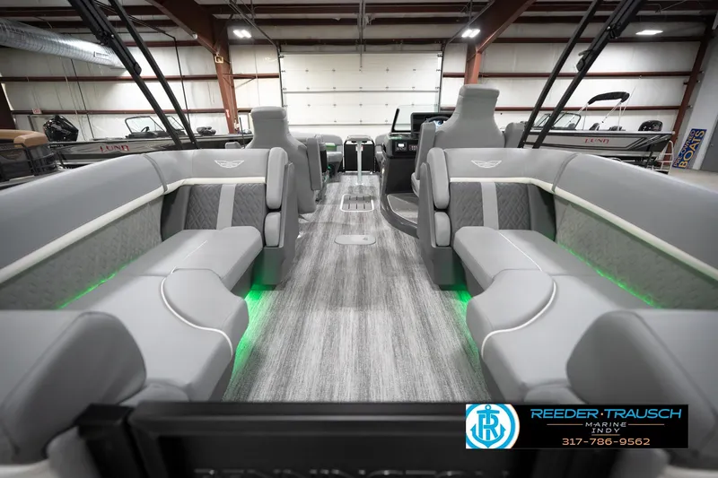 Slide: The Image of 2026 Bennington 24 MFB boat interior with gray seating and green accent lighting. - 72
