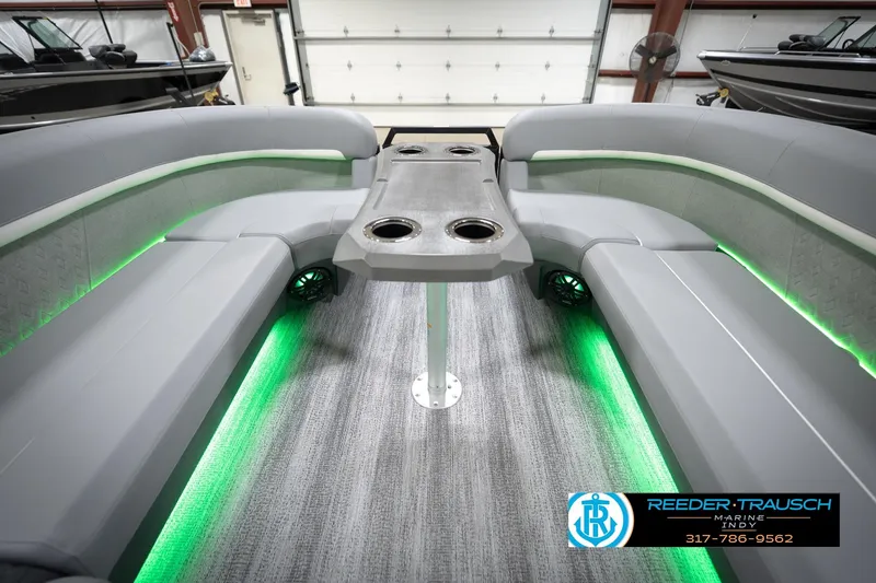 Slide: The Image of 2026 Bennington 24 MFB boat interior with gray seating and green LED lighting. - 74