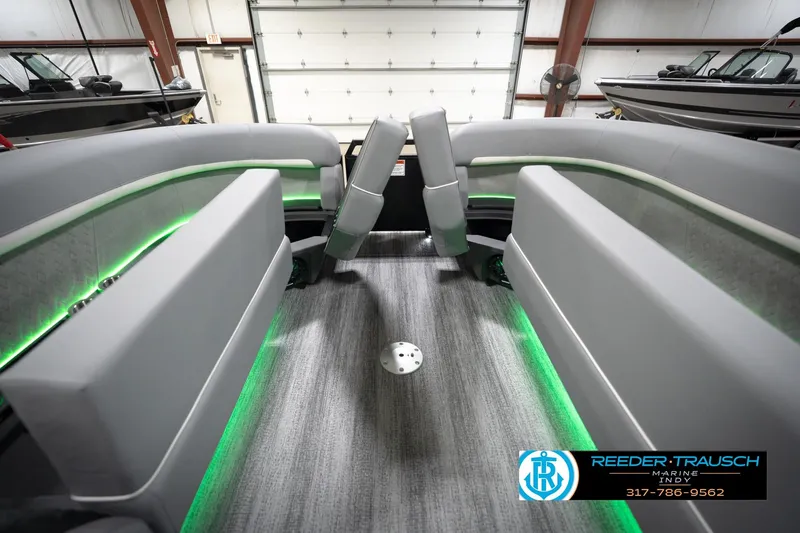 Slide: The Image of 2026 Bennington 24 MFB boat interior with gray seating and green LED lighting. - 76