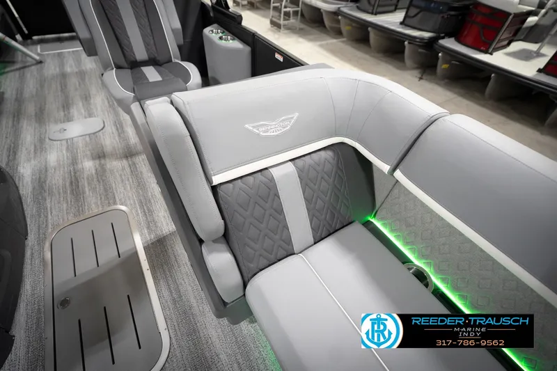 Slide: The Image of 2026 Bennington 24 MFB boat interior with gray seating and green LED lighting. - 77