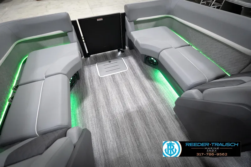 Slide: The Image of 2026 Bennington 24 MFB boat interior with gray seating and green LED lighting. - 79