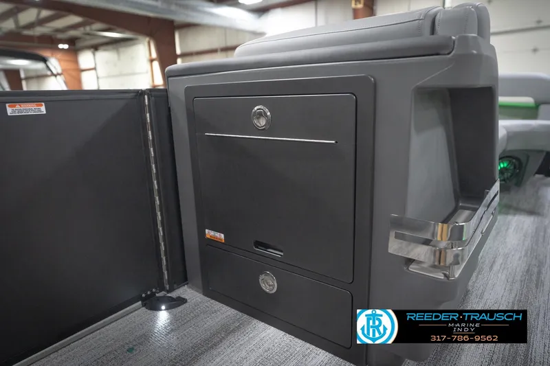 Slide: The Image of 2026 Bennington 24 MFB boat interior with storage compartments and cup holder. - 81