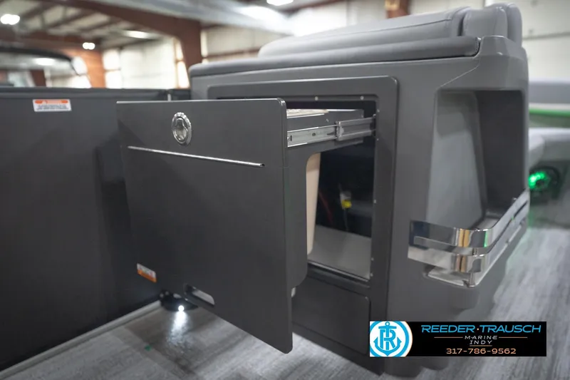 Slide: The Image of 2026 Bennington 24 MFB boat interior with storage compartment open, showcasing modern design. - 82