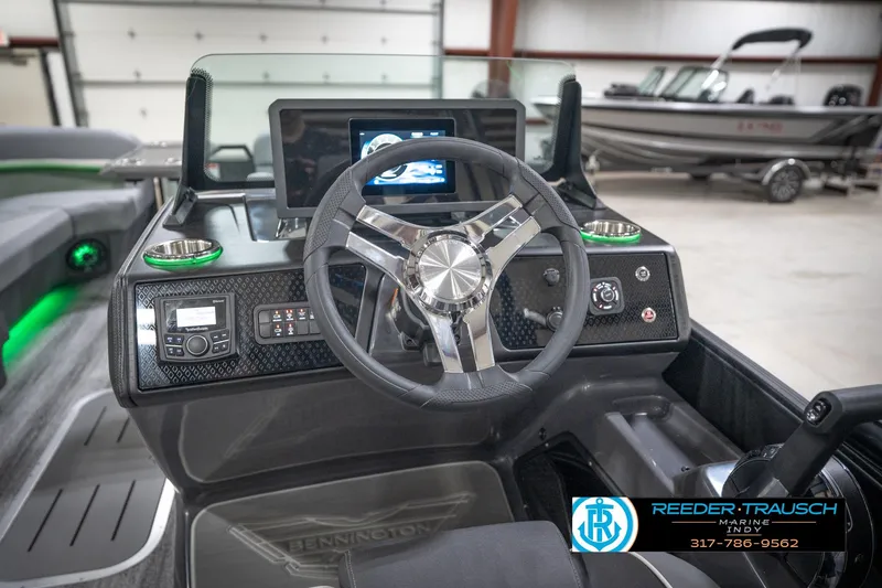 Slide: The Image of Interior of 2026 Bennington 24 MFB boat with modern steering and control panel. - 85