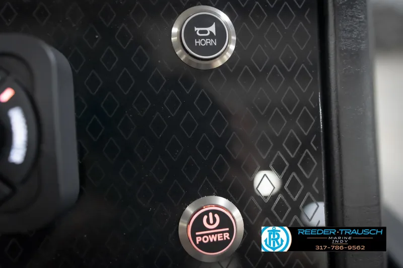 Slide: The Image of Close-up of 2026 Bennington 24 MFB dashboard with horn and power buttons. - 91