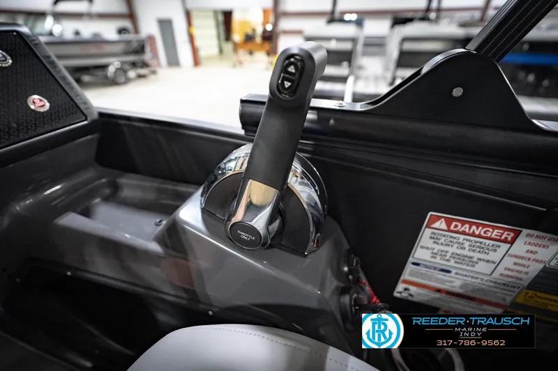 Slide: The Image of Throttle control of 2026 Bennington 24 MFB boat with safety warning label. - 92