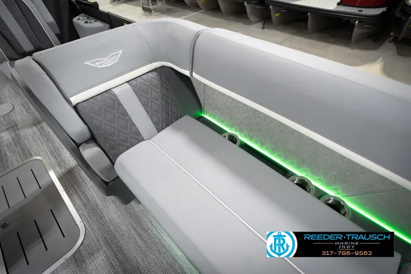 Slide: The Image of 2026 Bennington 24 MFB boat interior with gray seating and green LED lighting. - 95