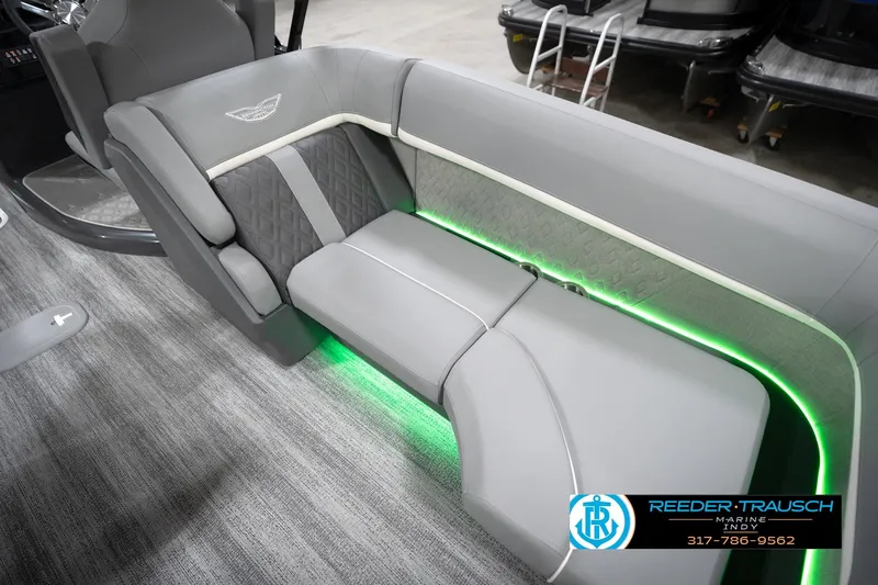 Slide: The Image of Luxurious seating in 2026 Bennington 24 MFB boat with ambient green lighting. - 97