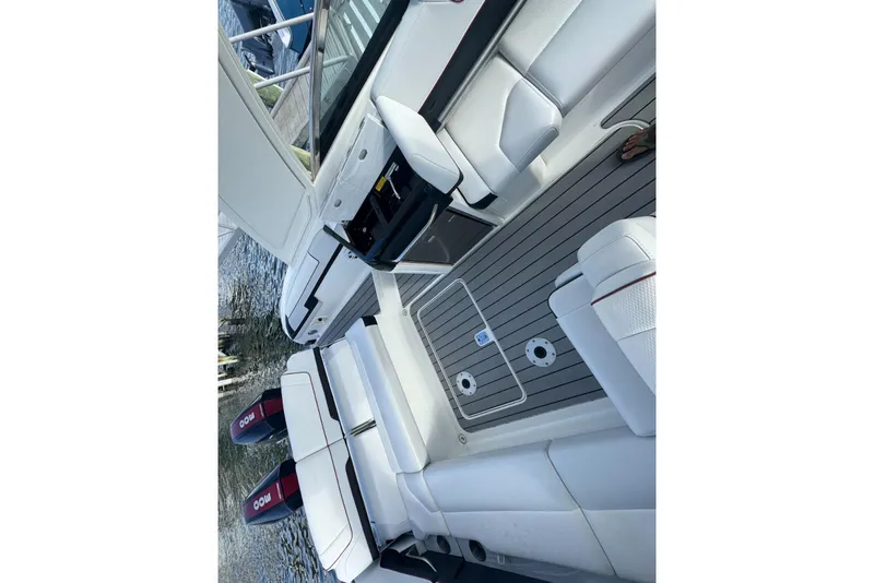 Slide: The Image of 2022 Formula 310 Bowrider OB interior with white seating and dual outboard motors. - 15