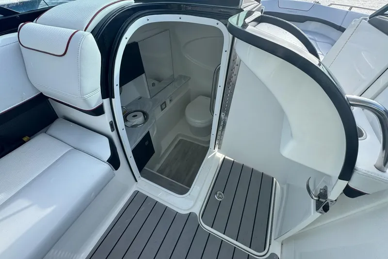 Slide: The Image of 2022 Formula 310 Bowrider OB interior with seating and compact restroom. - 18