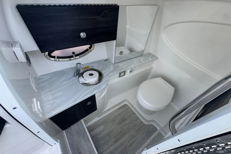 Slide: The Image of 2022 Formula 310 Bowrider OB boat bathroom with sink, toilet, and modern design. - 19