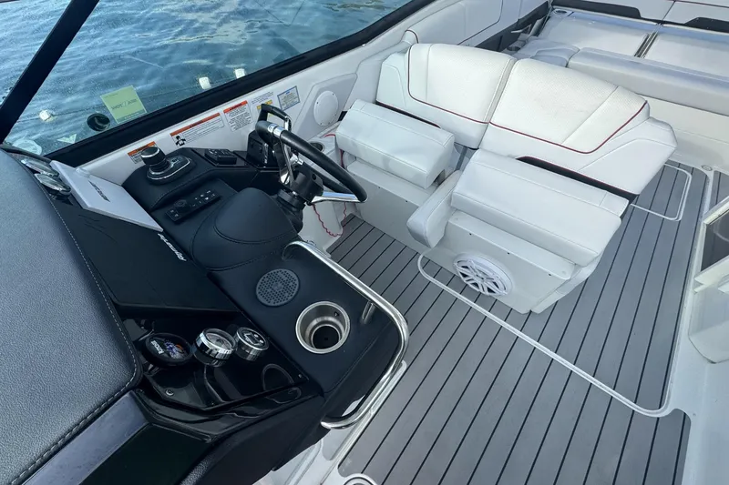 Slide: The Image of 2022 Formula 310 Bowrider OB cockpit with modern steering and white seating. - 6