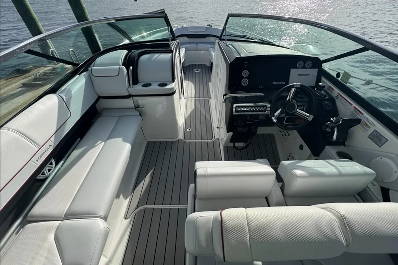 Slide: The Image of 2022 Formula 310 Bowrider OB interior with luxurious seating and modern dashboard. - 7
