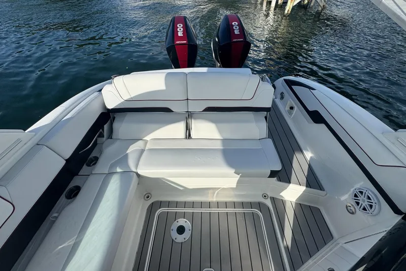 Slide: The Image of 2022 Formula 310 Bowrider OB boat interior with seating and twin outboard engines. - 8
