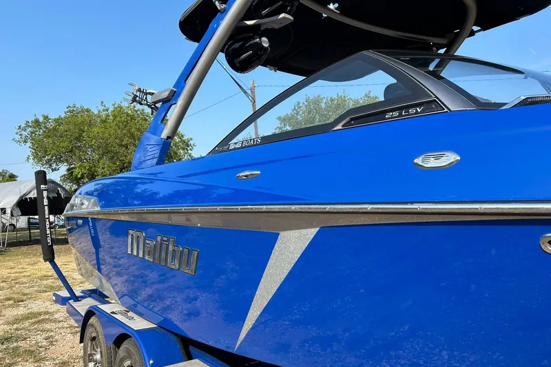 Slide: The Image of Blue 2017 Malibu Wakesetter 25 LSV boat on trailer, side view. - 10