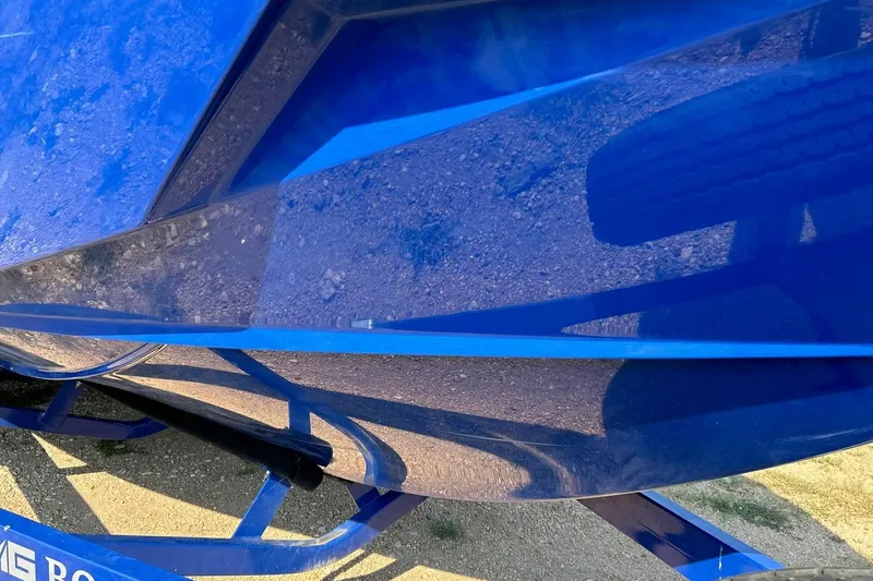 Slide: The Image of Close-up of a blue 2017 Malibu Wakesetter 25 LSV boat hull on a trailer. - 12