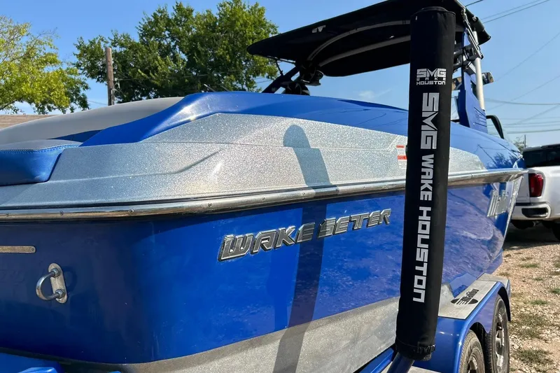 Slide: The Image of 2017 Malibu Wakesetter 25 LSV boat in vibrant blue, parked outdoors. - 15