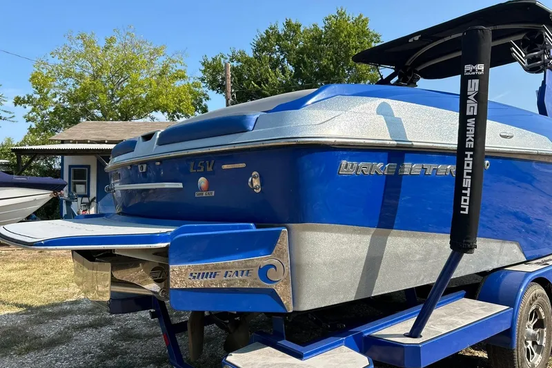 Slide: The Image of 2017 Malibu Wakesetter 25 LSV boat, blue exterior, parked outdoors. - 16