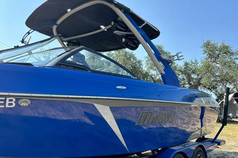 Slide: The Image of 2017 Malibu Wakesetter 25 LSV boat in vibrant blue with sleek design. - 18