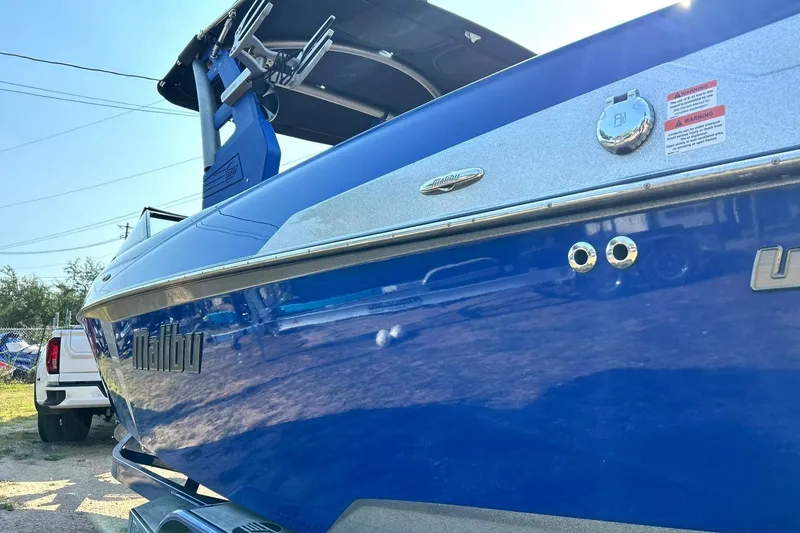 Slide: The Image of 2017 Malibu Wakesetter 25 LSV boat, blue exterior, parked outdoors. - 20