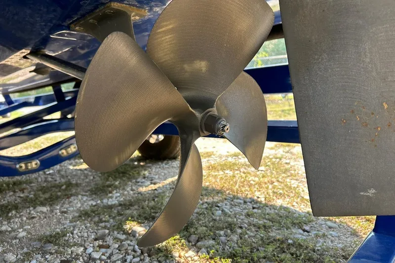 Slide: The Image of Close-up of 2017 Malibu Wakesetter 25 LSV boat propeller on gravel surface. - 23