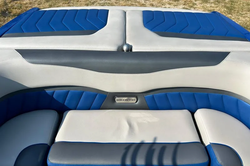 Slide: The Image of 2017 Malibu Wakesetter 25 LSV boat interior with blue and gray seating. - 28