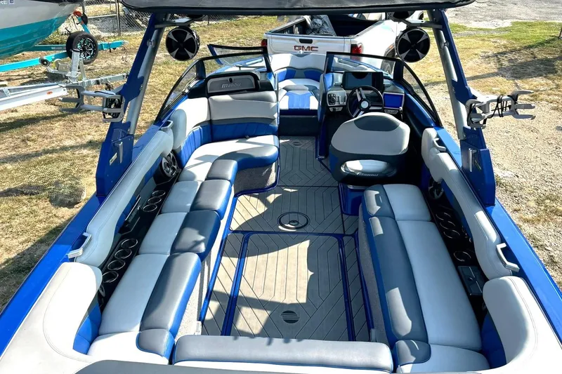 Slide: The Image of 2017 Malibu Wakesetter 25 LSV boat interior with blue and gray seating. - 3
